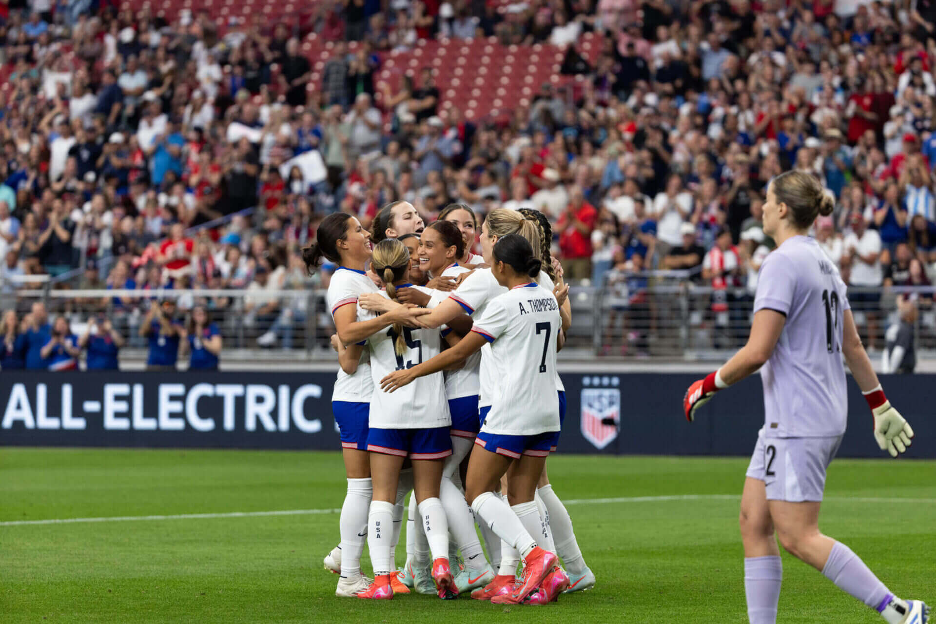 Team mates hugging each other on a field